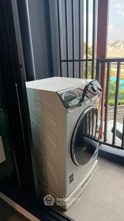 Modern washing machine on a balcony with urban view