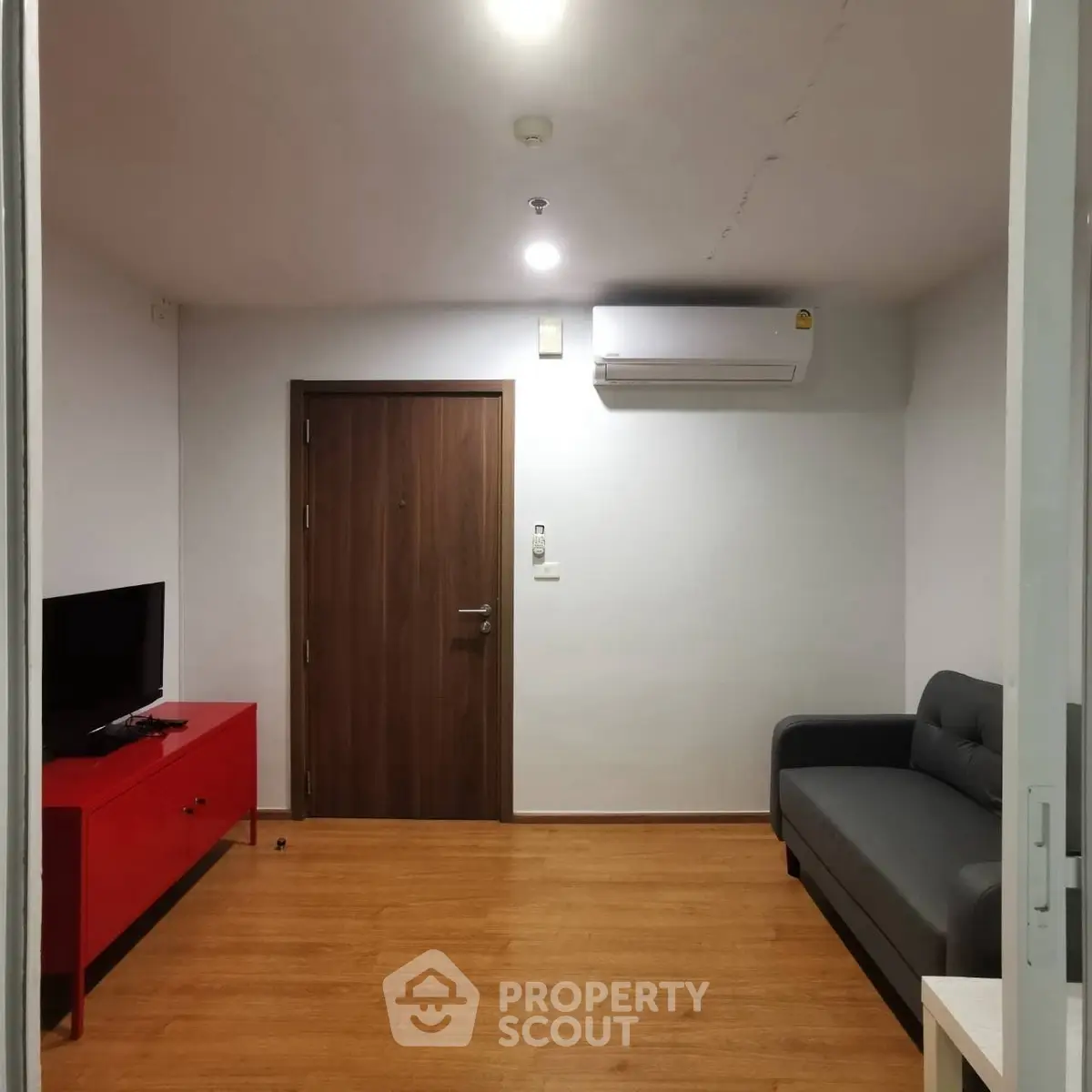 Modern living room with sleek furniture and wooden flooring