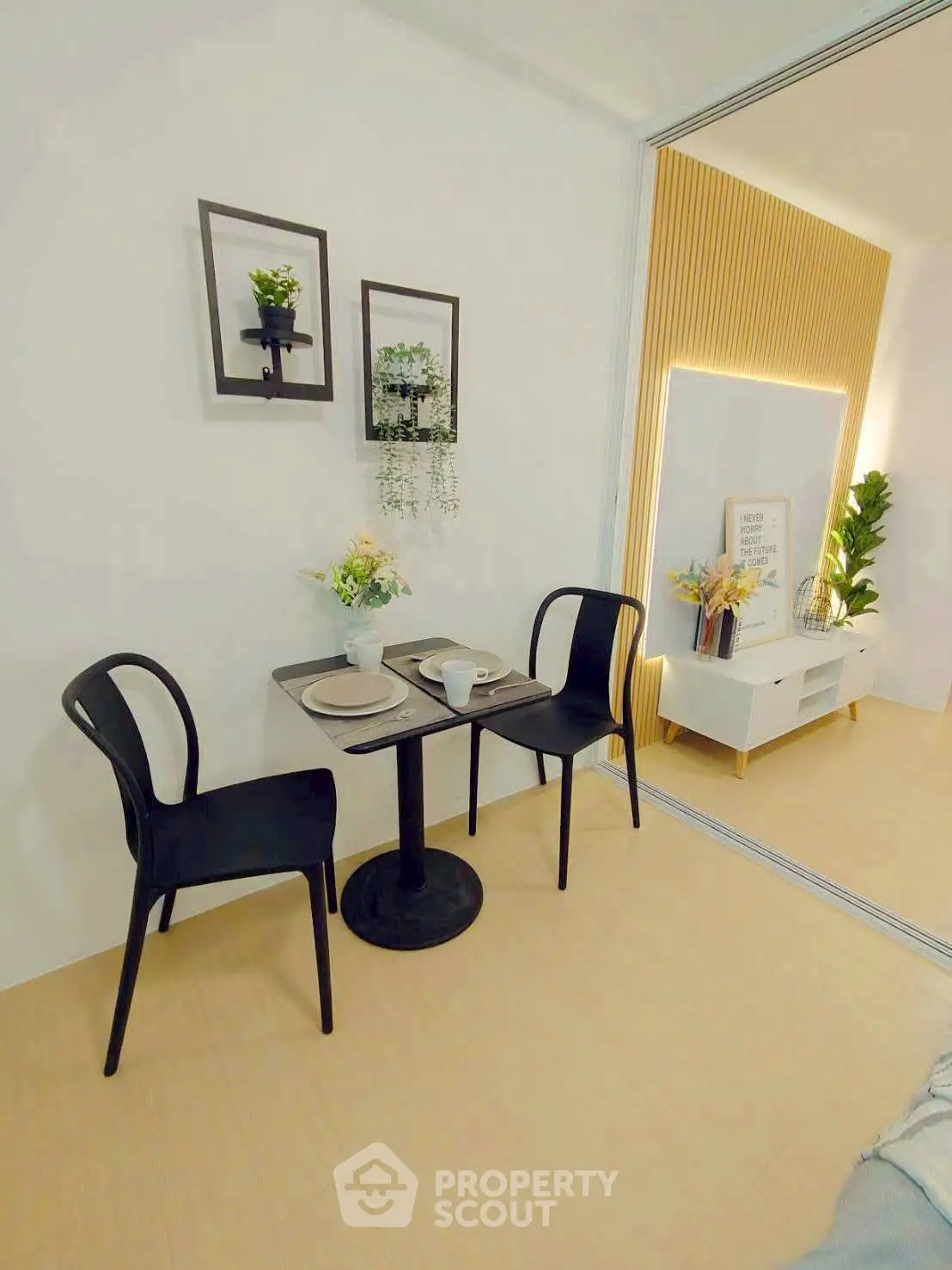 Chic modern dining area with stylish decor and elegant black chairs, perfect for cozy meals.