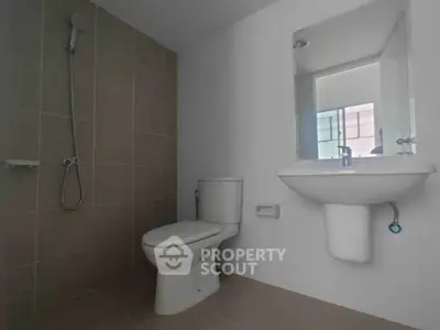 Modern bathroom with shower and sleek fixtures in a contemporary home.