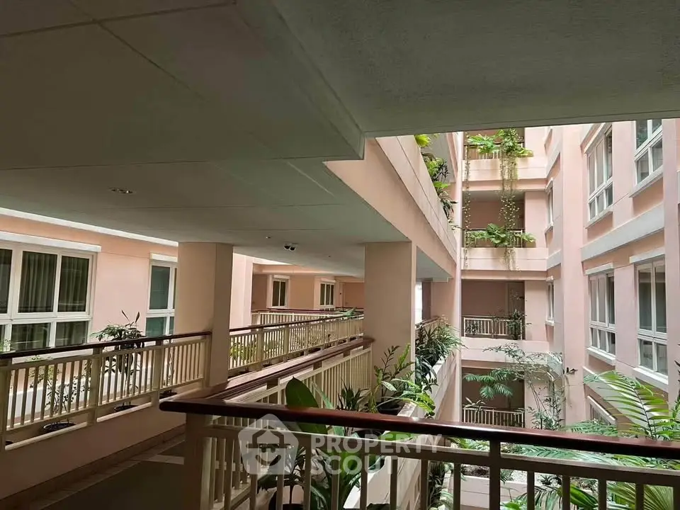 Spacious apartment building with lush greenery and modern design.