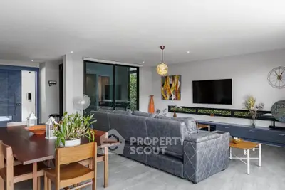 Spacious modern living room with stylish decor and large windows for natural light.