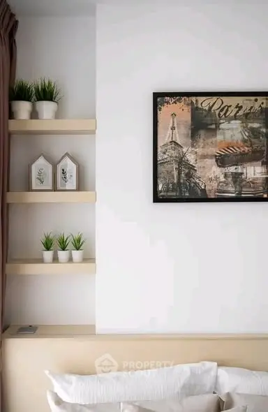 Stylish bedroom with modern decor and elegant wall art, perfect for a cozy and inviting atmosphere.