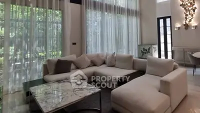 Luxurious modern living room with large windows and elegant decor