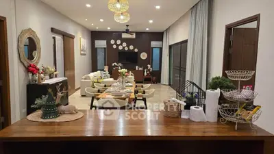 Spacious open-layout living and dining area with elegant decor and modern lighting.