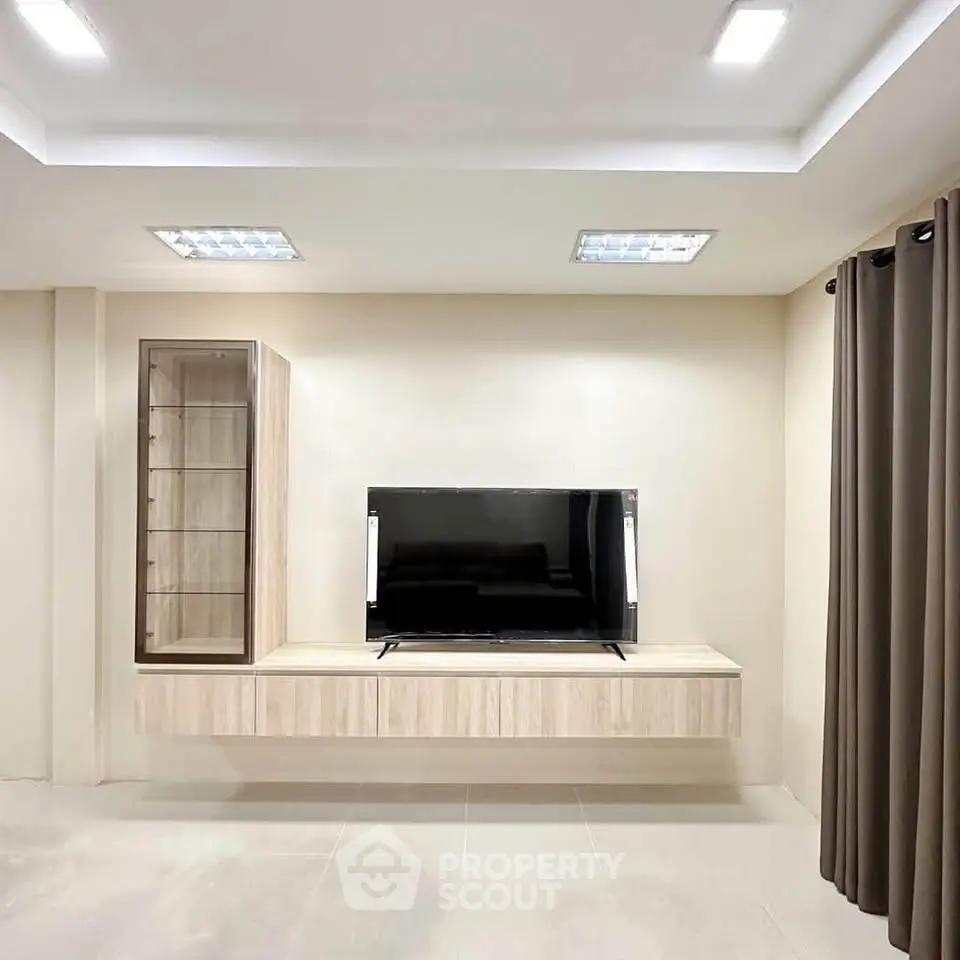 Modern living room with sleek TV unit and elegant lighting
