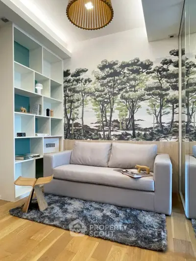 Stylish living room with modern sofa, artistic wall mural, and elegant shelving.