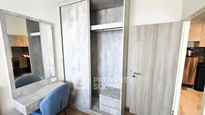 Modern bedroom with stylish wardrobe and vanity set in contemporary apartment