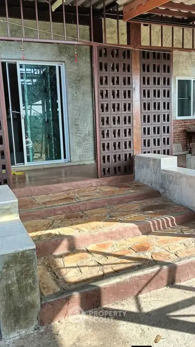 Charming rustic entrance with stone steps and wooden lattice panels, perfect for a cozy home ambiance.
