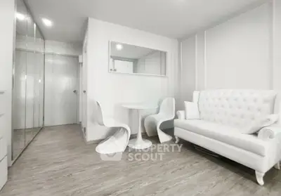 Modern living room with elegant white furniture and sleek wooden flooring