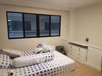 Cozy bedroom with modern decor and ample natural light