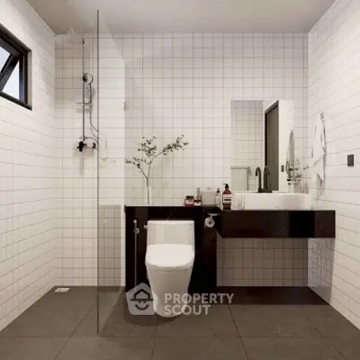 Modern bathroom with sleek fixtures and minimalist design, featuring a glass shower and stylish vanity.