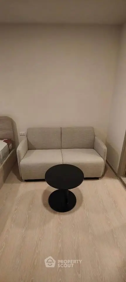 Cozy living room with modern sofa and round coffee table on wooden floor