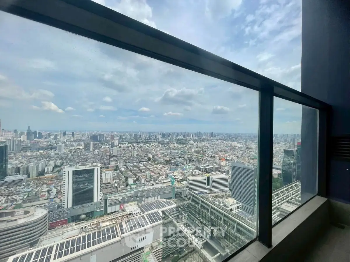 Stunning cityscape view from a high-rise balcony with expansive skyline and modern architecture.