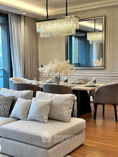 Luxurious living room with elegant dining area and modern chandelier