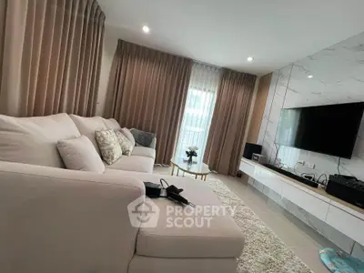 Luxurious modern living room with elegant decor and large TV