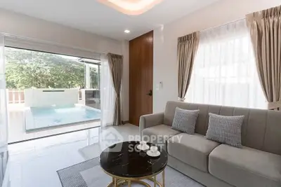 Modern living room with pool view and elegant decor