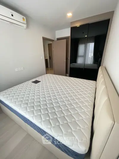 Modern bedroom with sleek design and comfortable mattress in a stylish apartment.