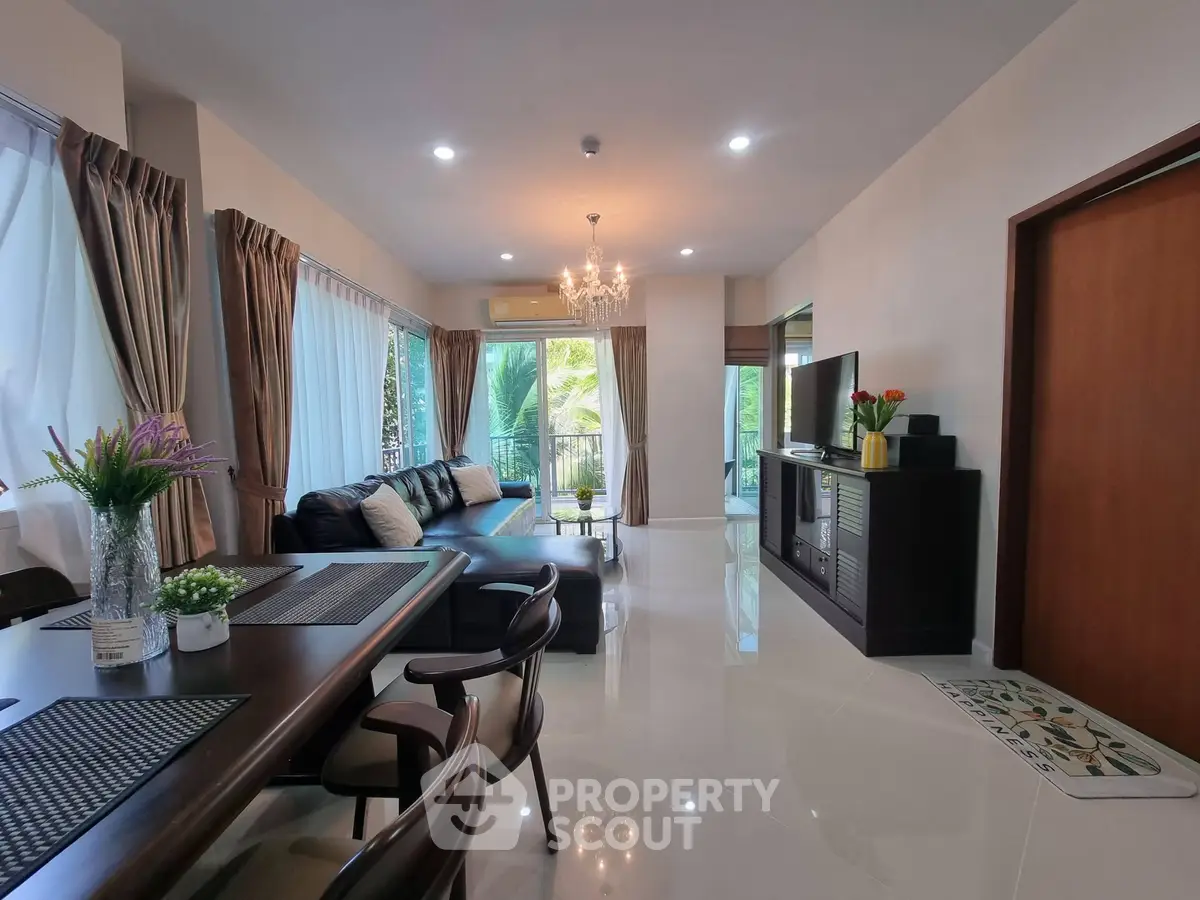 Spacious modern living room with elegant decor and large windows for natural light.