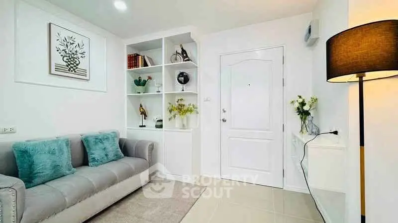 Stylish living room with modern decor and cozy seating in a bright apartment.