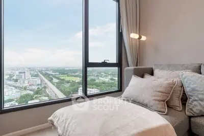 Luxurious living room with panoramic city view from high-rise apartment window.
