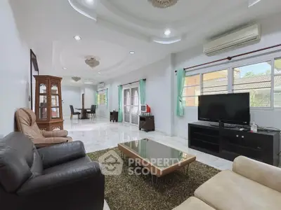 Spacious living room with modern furniture and large windows for natural light.