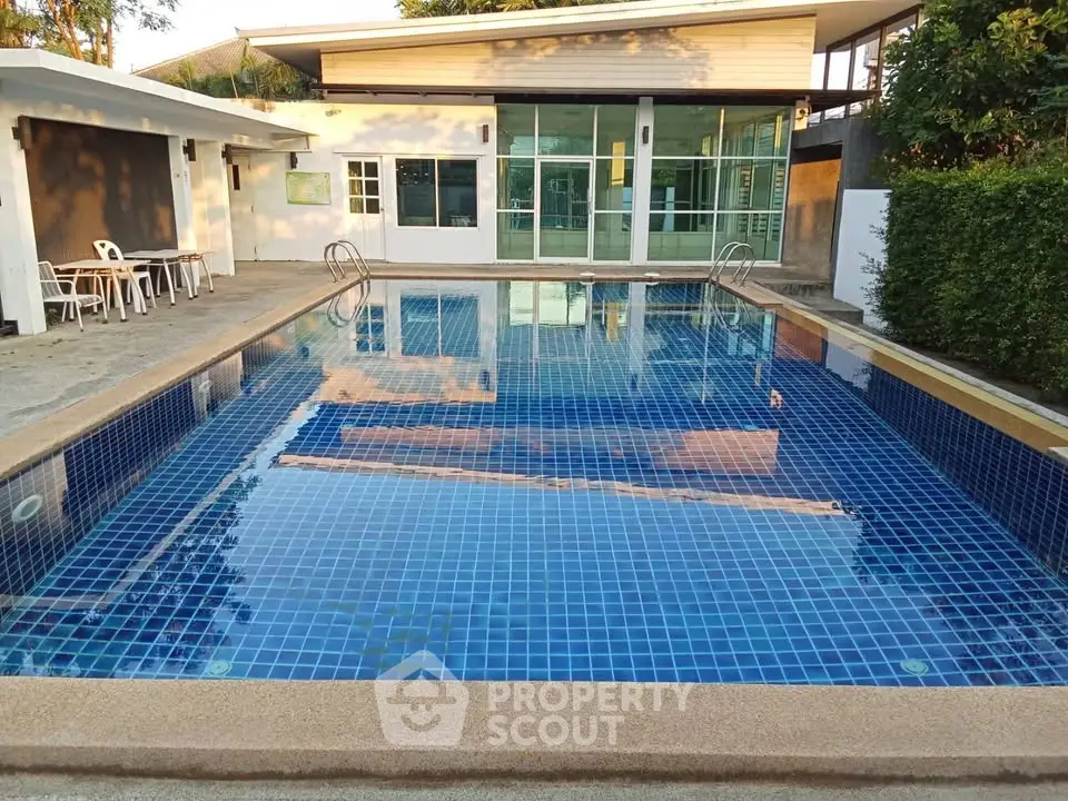 Stunning residential pool area with modern design and lush greenery, perfect for relaxation and leisure.