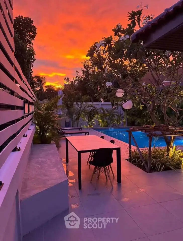 Stunning outdoor pool area with vibrant sunset view, perfect for relaxation and entertainment.