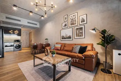Modern living room with stylish decor, leather sofa, and open kitchen layout in luxury apartment.