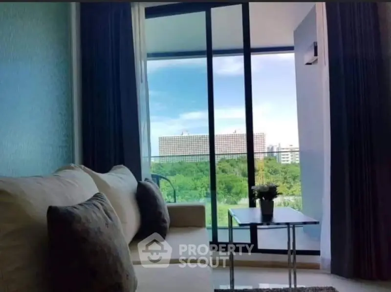 Modern living room with large windows offering a stunning city view.