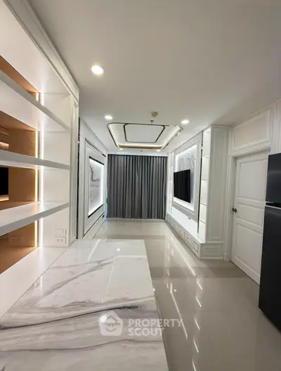 Luxurious modern living room with elegant marble flooring and stylish built-in shelving.