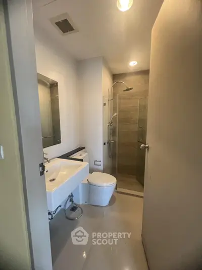 Modern bathroom with sleek fixtures and glass shower enclosure