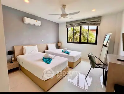 Modern twin bedroom with air conditioning and natural light, perfect for comfort and relaxation.