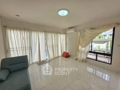 Spacious living room with large windows and modern decor