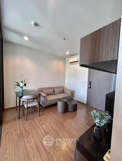 Modern living room with stylish furniture and wooden flooring in a cozy apartment.