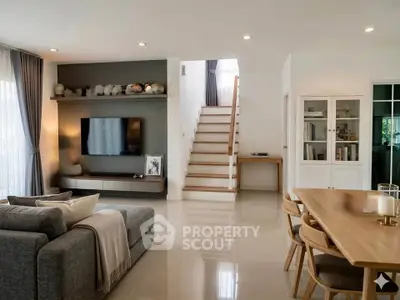Modern living room with sleek furniture and stylish decor, featuring a cozy sofa and elegant dining area.