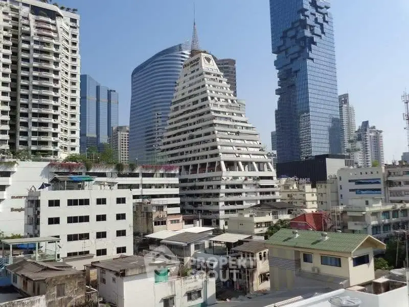 Stunning urban skyline with unique pyramid-shaped building and modern skyscrapers.
