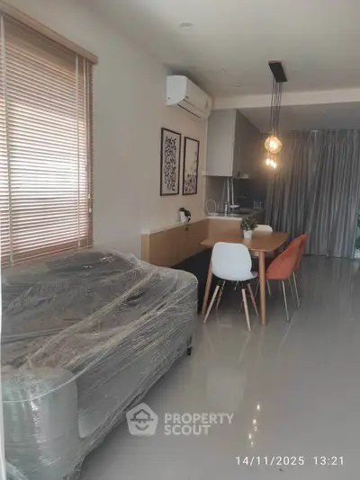 Modern living room with dining area and sleek kitchen design