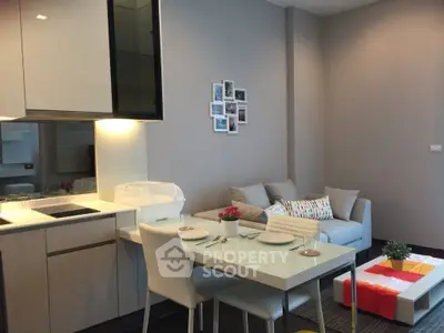 Modern open-layout kitchen and cozy living room with stylish decor and dining area.