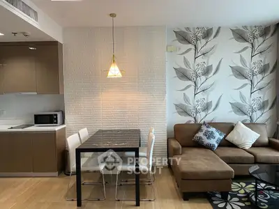 Modern living room with stylish decor, featuring a cozy sofa, dining area, and elegant lighting.