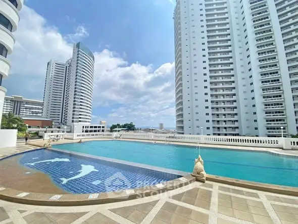 Luxurious high-rise building with stunning rooftop pool and city views.