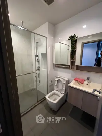 Modern bathroom with glass shower and sleek fixtures
