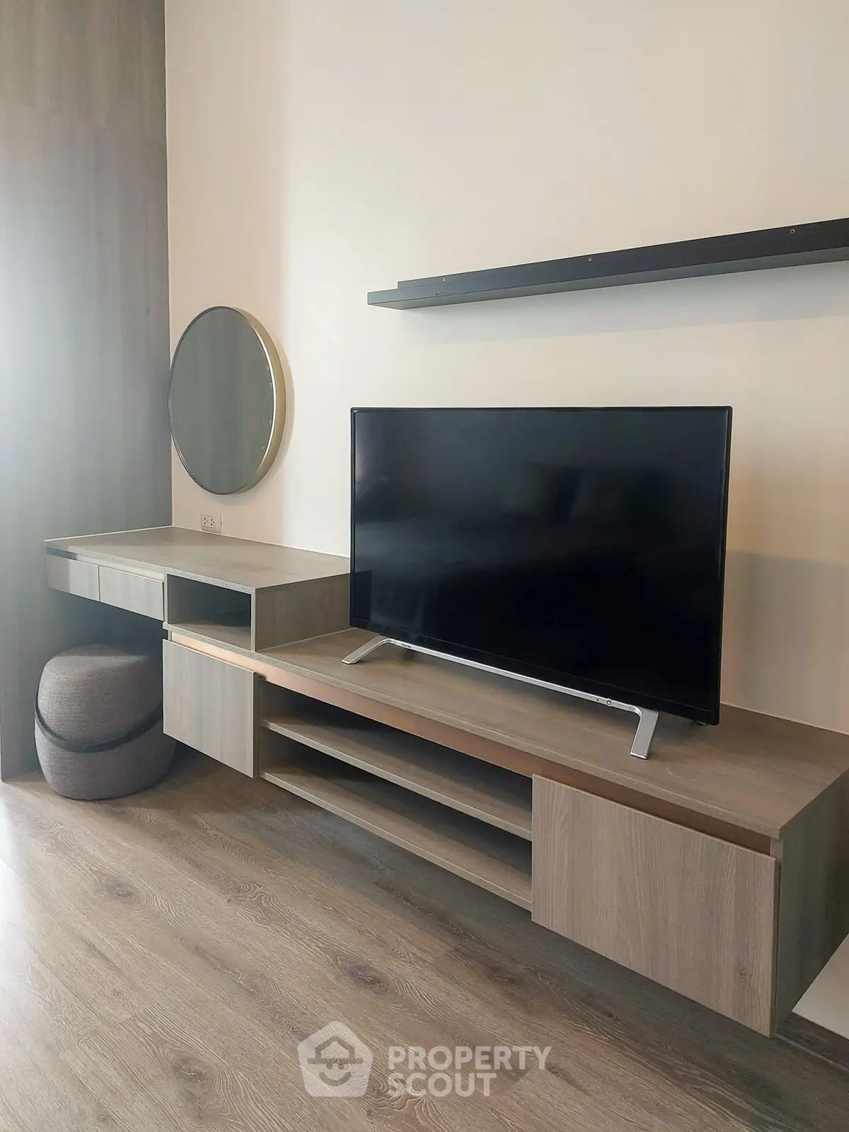 Modern living room with sleek TV stand and wall-mounted shelves, perfect for contemporary living.