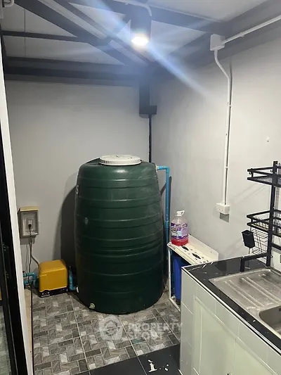 Utility room with water tank and sink in modern home