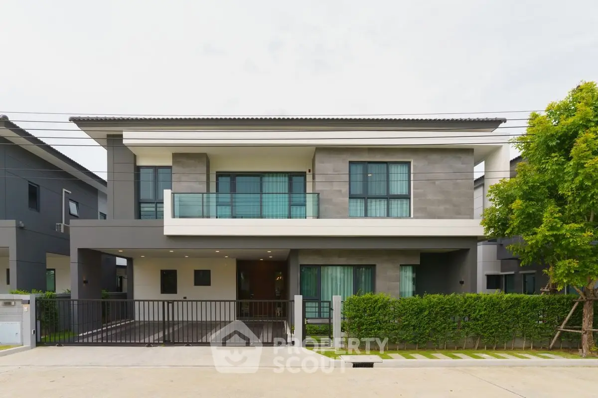 Modern two-story house with sleek facade and large windows