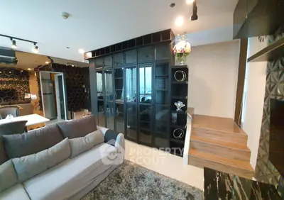 Modern living room with stylish black shelving and cozy gray sofa