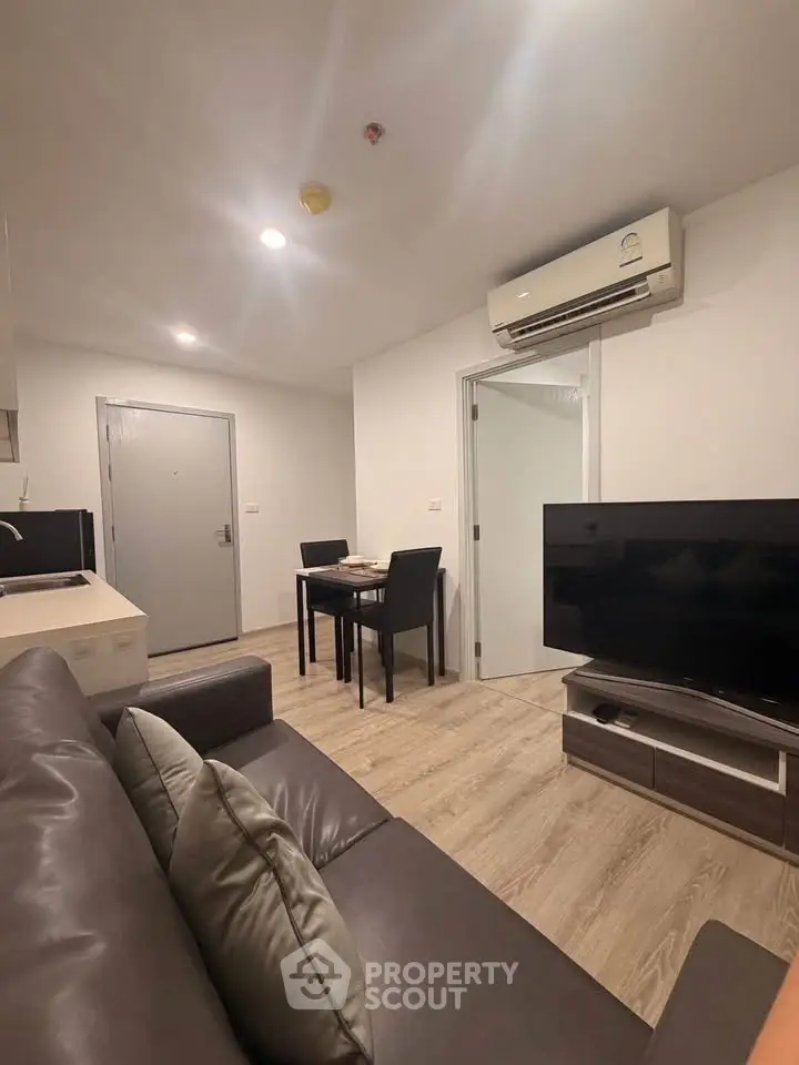 Modern living room with sleek furniture and air conditioning in a cozy apartment.