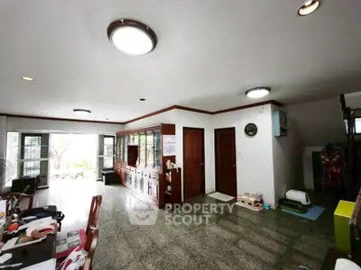 Spacious living room with elegant wooden cabinetry and ample natural light