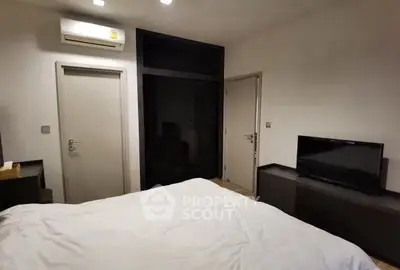 Cozy bedroom with modern furnishings and air conditioning unit