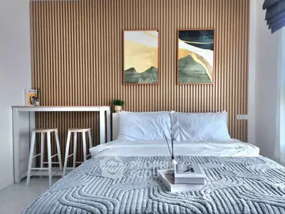 Modern bedroom with stylish decor and cozy bedding in a contemporary apartment.